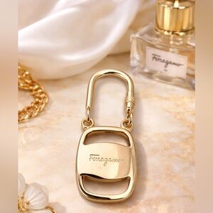 FERRAGAMO gold carabiner key ring/bag charm w/ engraved logo. Minimalist design.